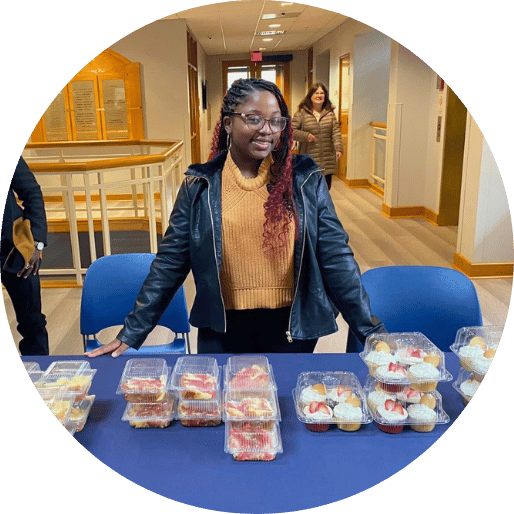 Student setting up table for bake sale