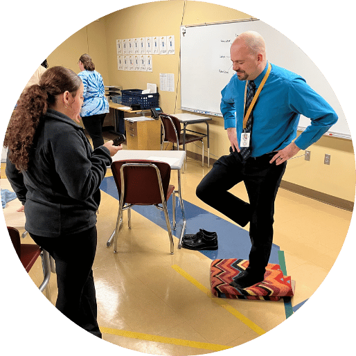 Teacher balancing on one leg