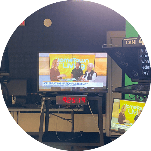 Student on TV next to teleprompter